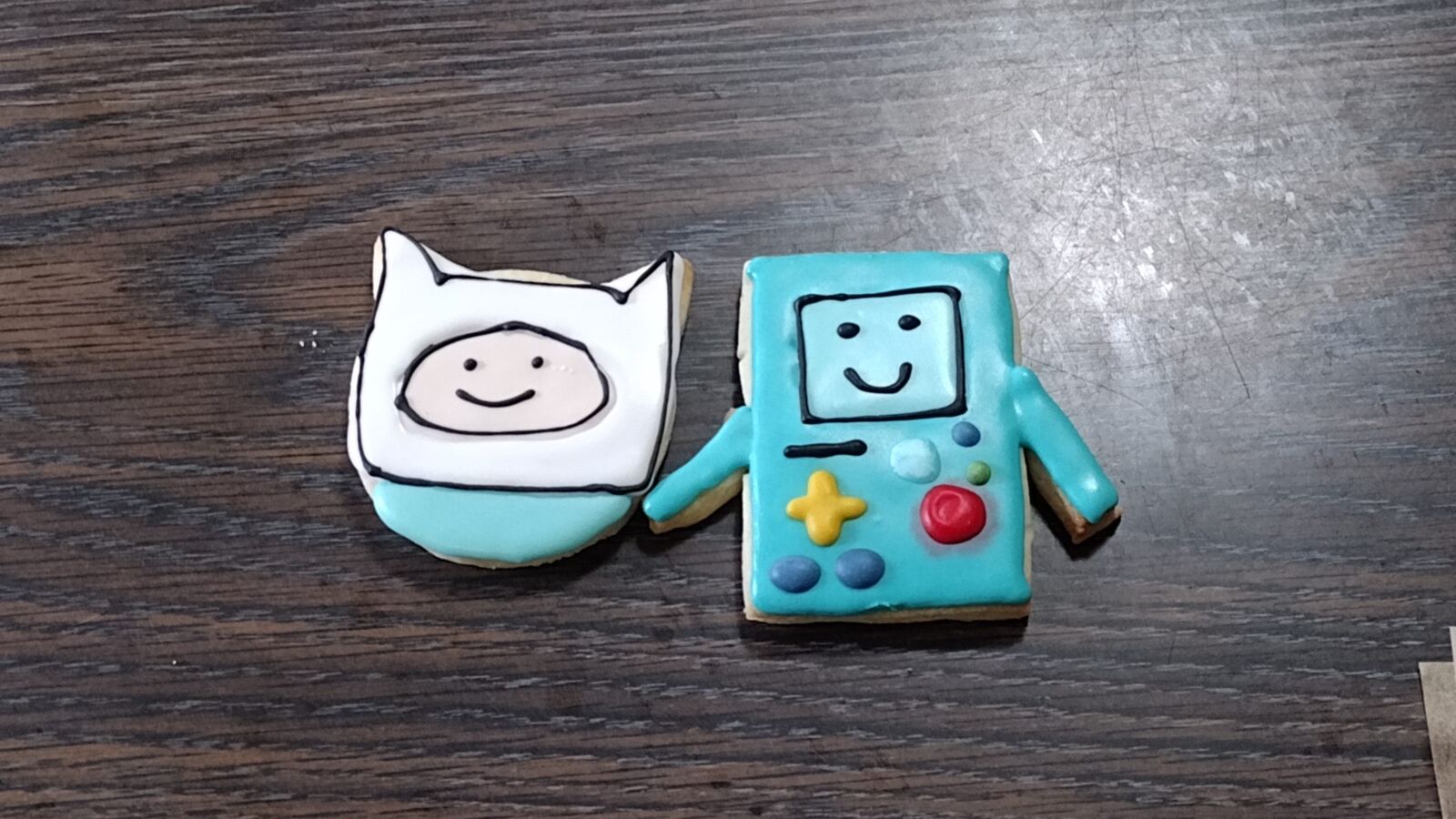 A tray of hand-decorated sugar cookies made by 2 Cute 2 Eat Cookies